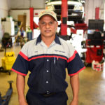 An auto mechanic standing