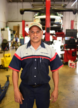 An auto mechanic standing